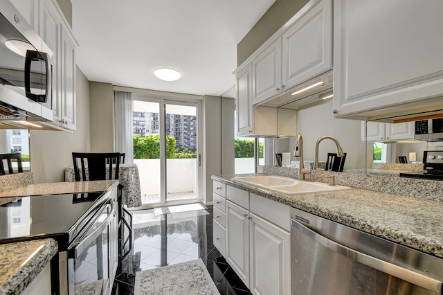 kitchen featuring white cabinets, light stone countertops, sink, and appliances with stainless steel finishes