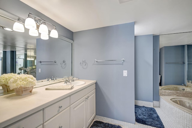 bathroom with tiled bath, tile patterned flooring, and vanity