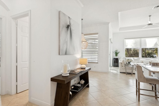 interior space featuring light tile patterned floors and crown molding