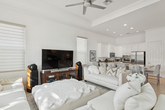 living room with crown molding, light tile patterned floors, and ceiling fan