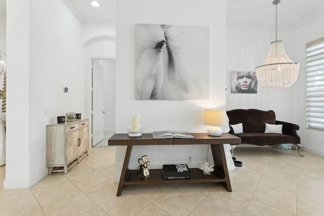 living room with light tile patterned floors, a notable chandelier, and ornamental molding