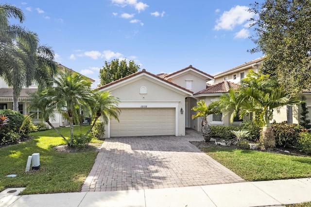 mediterranean / spanish house featuring a garage and a front lawn