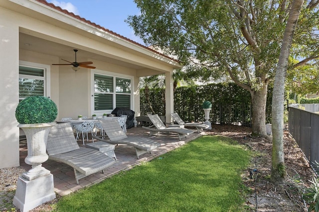 view of patio featuring area for grilling and ceiling fan