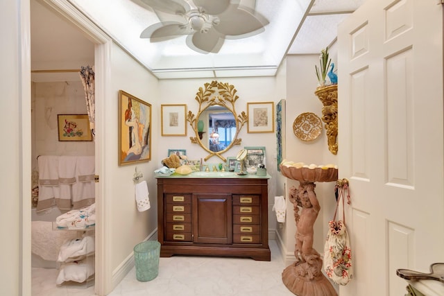 bathroom with ceiling fan and vanity