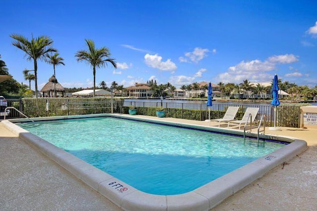 view of pool with a water view