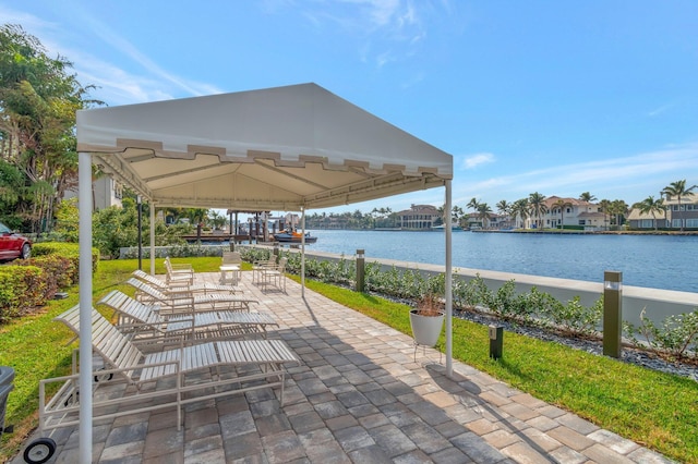 view of patio with a gazebo and a water view