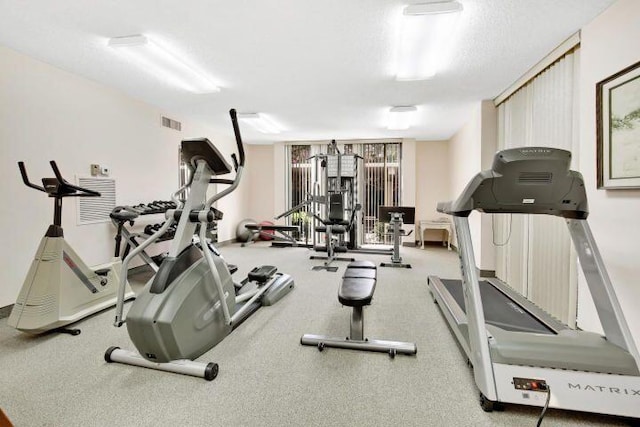 workout area with a textured ceiling