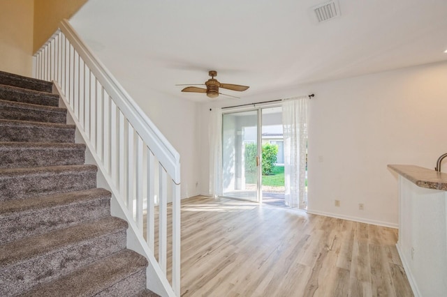 unfurnished living room featuring light hardwood / wood-style floors and ceiling fan