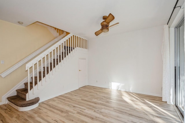 unfurnished living room featuring hardwood / wood-style floors and ceiling fan