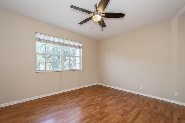 spare room with wood-type flooring and ceiling fan