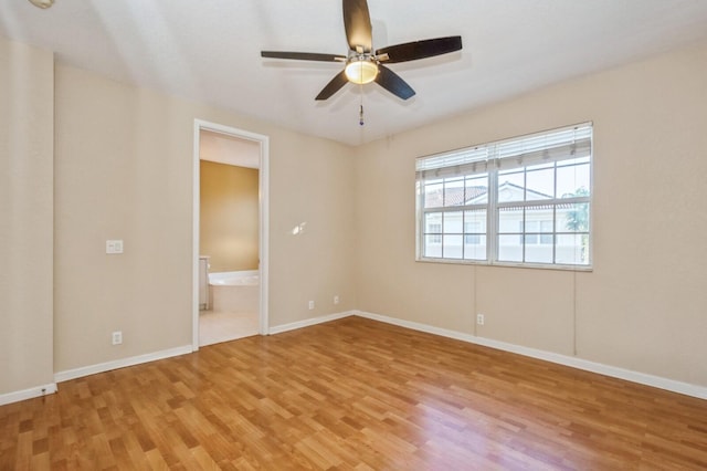 unfurnished bedroom featuring light wood-type flooring, ensuite bath, and ceiling fan