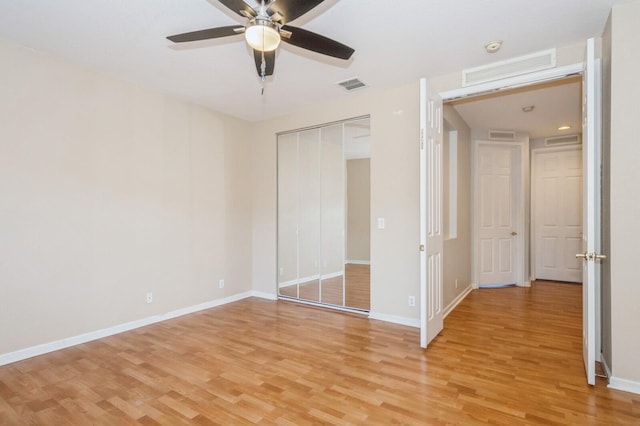 unfurnished bedroom with ceiling fan, a closet, and light hardwood / wood-style flooring