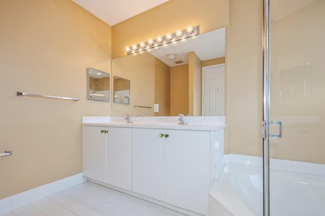 bathroom with tile patterned floors, vanity, and plus walk in shower