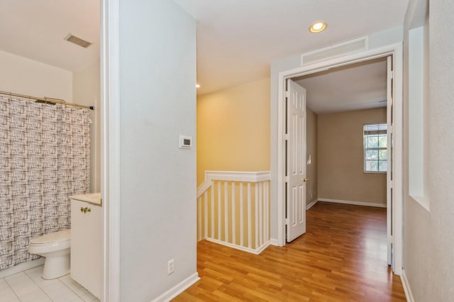 corridor with light hardwood / wood-style flooring