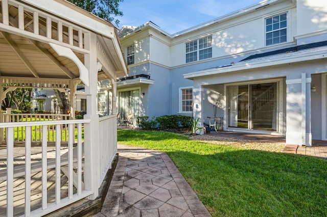 back of property featuring a yard