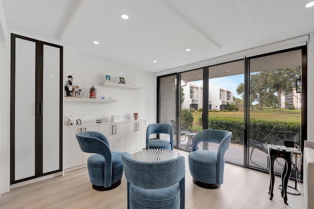 living area featuring light hardwood / wood-style floors and floor to ceiling windows