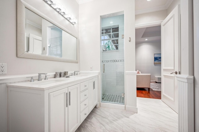 bathroom with wood-type flooring, vanity, a shower with shower door, and ornamental molding