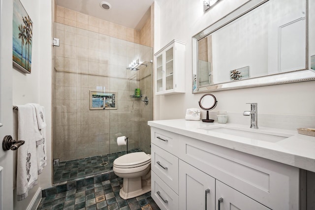 bathroom with vanity, toilet, and a shower with shower door