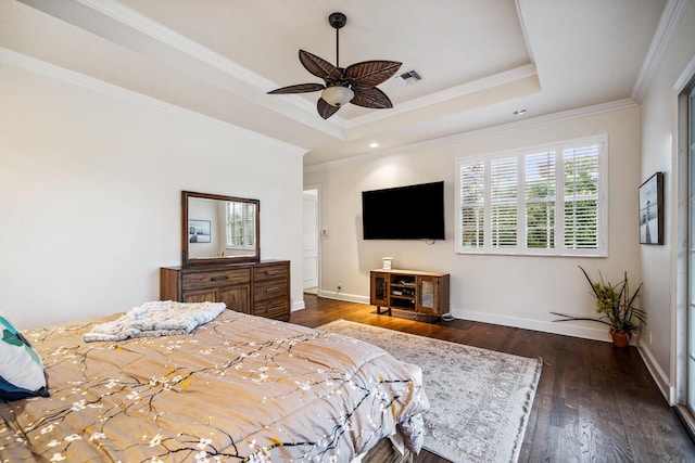 bedroom featuring ornamental molding, dark hardwood / wood-style floors, ceiling fan, and a tray ceiling