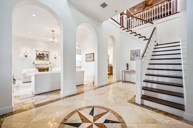 entrance foyer with a notable chandelier and ornamental molding