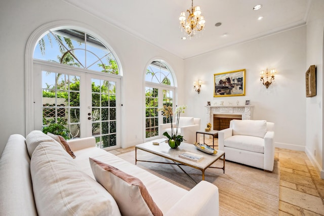 living room featuring french doors, a chandelier, and ornamental molding