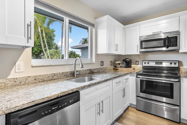 kitchen featuring white cabinetry, sink, and appliances with stainless steel finishes