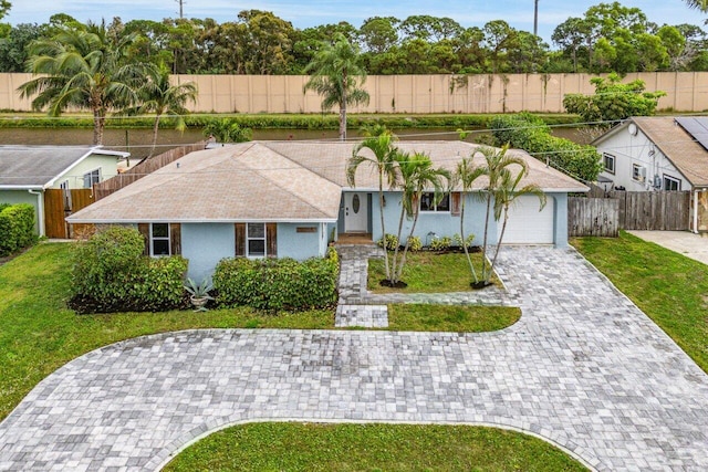 single story home with a front yard and a garage