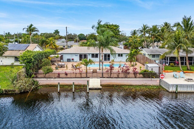 rear view of house with a water view and a patio