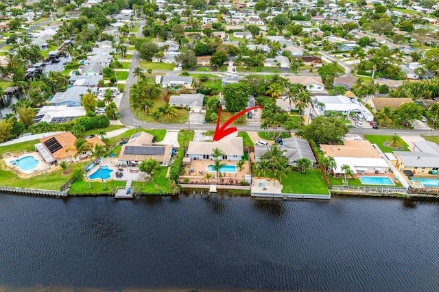 birds eye view of property with a water view