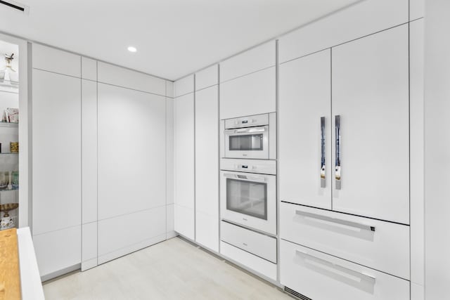 kitchen featuring white double oven and white cabinets