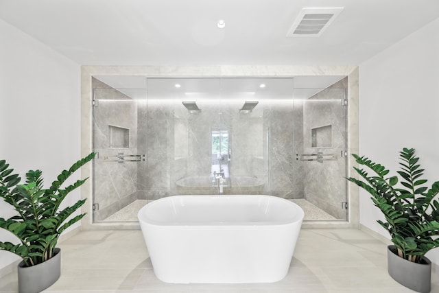 bathroom featuring separate shower and tub