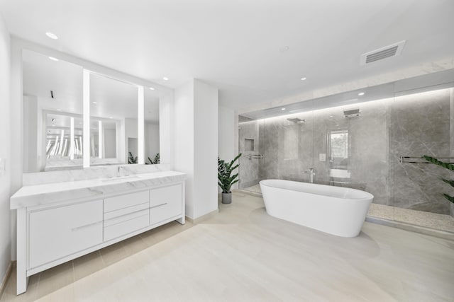 bathroom featuring vanity and separate shower and tub