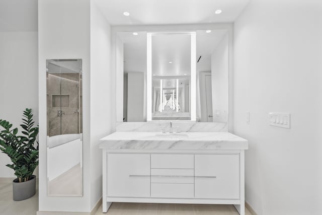 bathroom with vanity and a shower