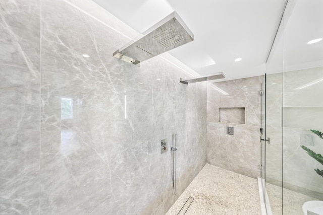 bathroom with a tile shower