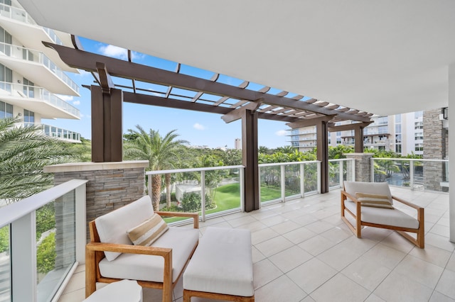 view of patio featuring a pergola and a balcony