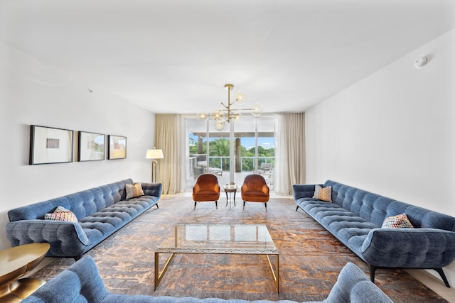 living room with a notable chandelier and a wall of windows