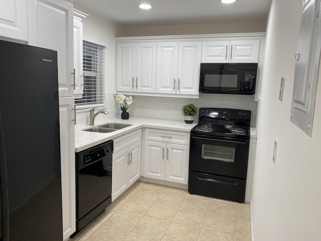 kitchen featuring black appliances, white cabinetry, sink, and tasteful backsplash