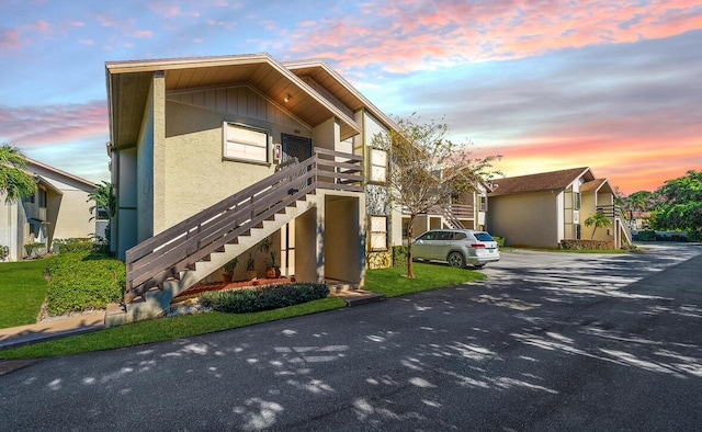 property at dusk featuring stairway