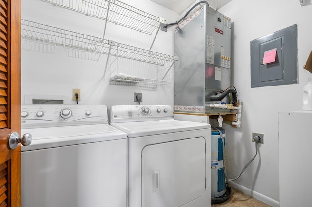 clothes washing area featuring washer and clothes dryer and electric panel