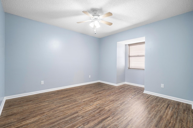 unfurnished room featuring ceiling fan, dark wood-type flooring, and a textured ceiling