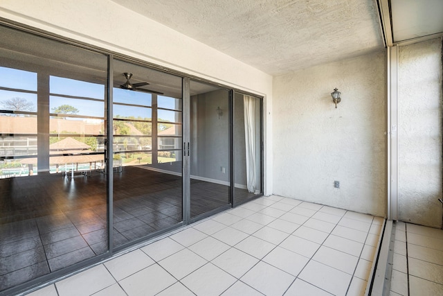 unfurnished sunroom with plenty of natural light and ceiling fan