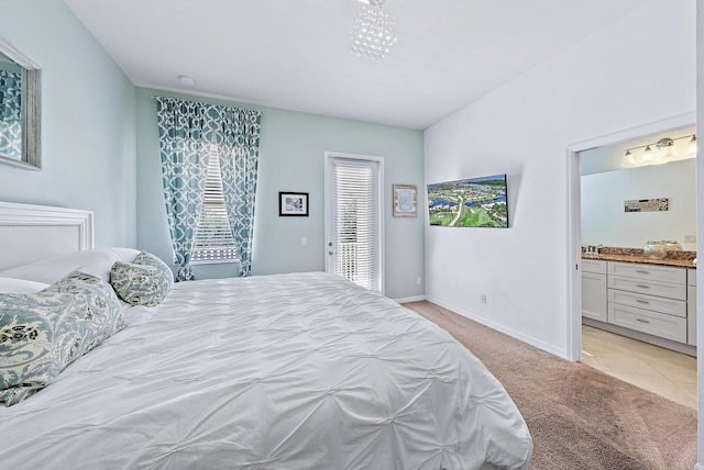 carpeted bedroom with ensuite bath