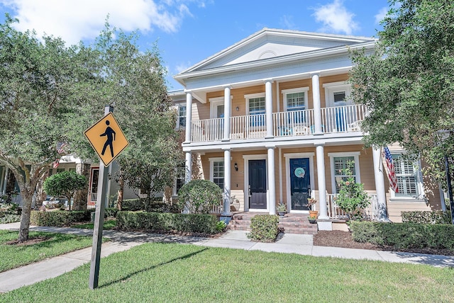 neoclassical / greek revival house featuring a balcony and covered porch