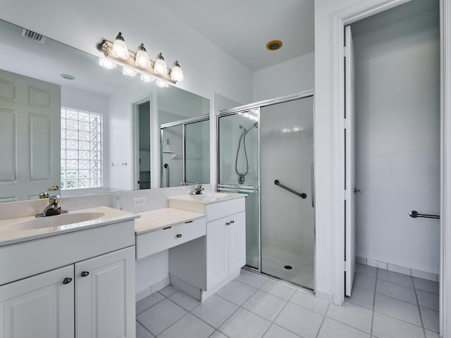 bathroom with tile patterned flooring, vanity, and a shower with shower door