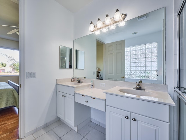 bathroom featuring vanity, a wealth of natural light, tile patterned flooring, and ceiling fan