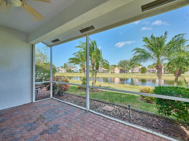 unfurnished sunroom with a water view