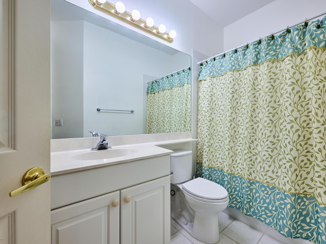 bathroom with toilet, a shower with curtain, vanity, and tile patterned floors