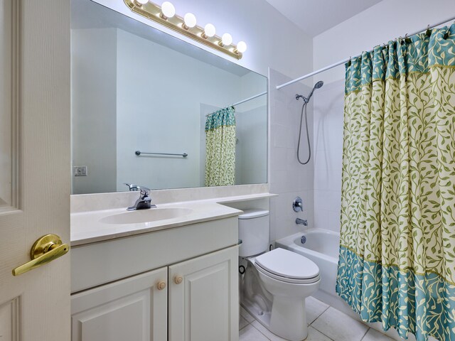 full bathroom featuring tile patterned flooring, vanity, toilet, and shower / bath combo with shower curtain