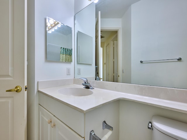 bathroom with vanity and toilet