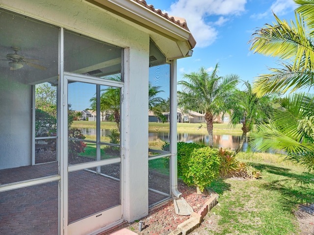 exterior space with a water view and ceiling fan